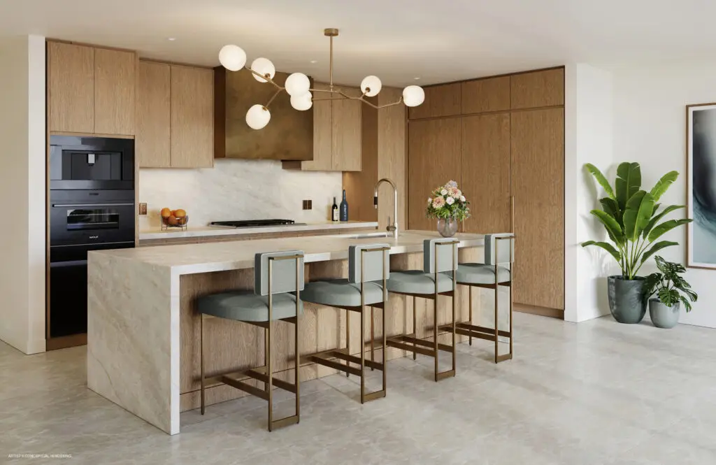 Residence kitchen with stone island, bar stools, pendant lighting and wood cabinetry at St. Regis Bahia Mar