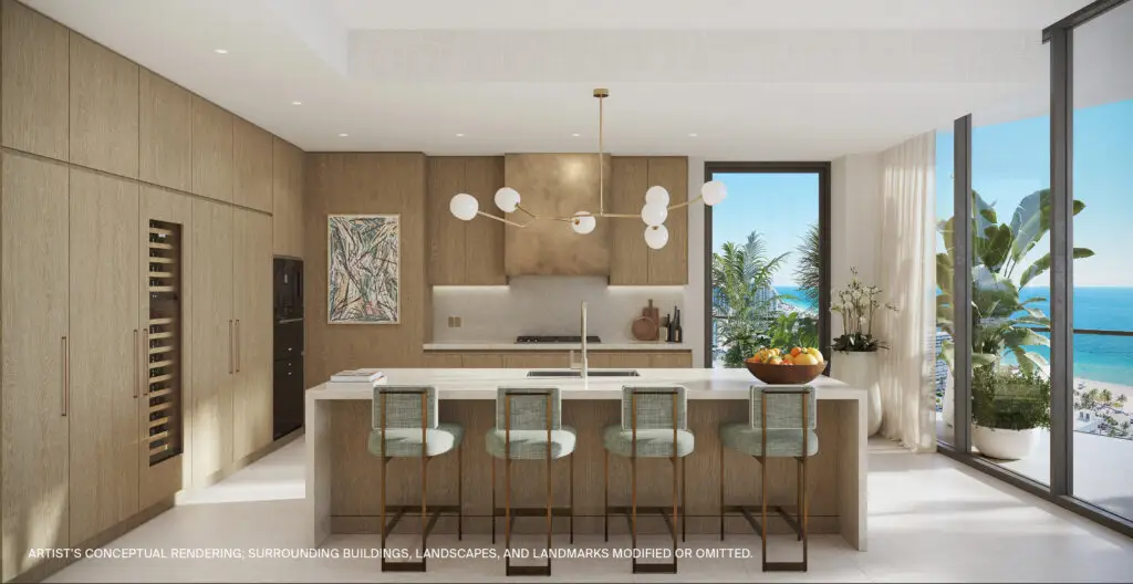 St. Regis Bahia Mar Unit 04 kitchen with island seating, wood cabinetry and pendant lighting
