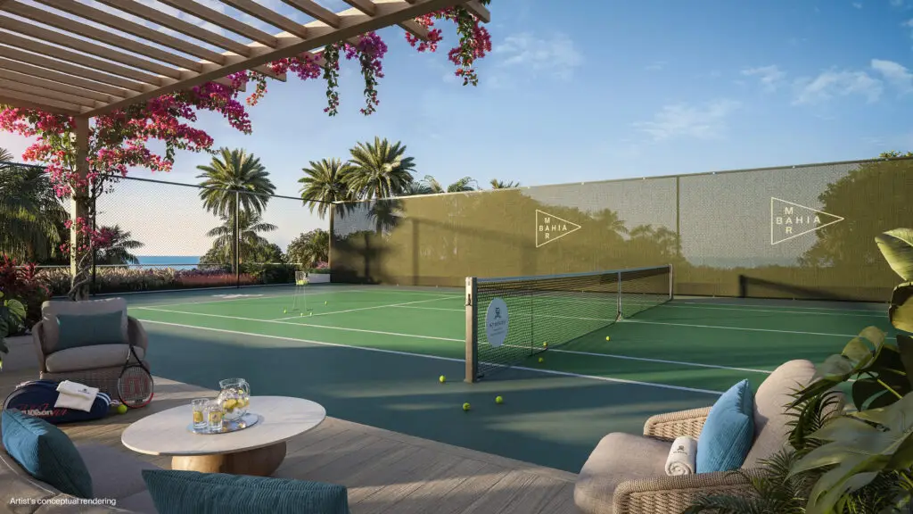 St. Regis Bahia Mar tennis court beside a shaded pergola lounge and tropical landscaping
